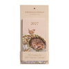 A slim, 2027 magnetic calendar in the colour light pink. Perfect to hang on the fridge. Featuring animal illustrations by Hannah Dale. Wrendale Designs