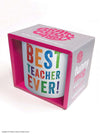 A cermaic mug featuring rainbow coloured text that reads "best teacher ever!" This mug is a perfect gift to show your teacher how much you appreciate them.