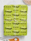 A gift wrapped in green wrapping paper, printed with the cheeky message 'stroppy teenager alet! Keep Clear Yeah?!' Perfect gift wrap for people who like to joke.