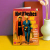 Funny woman's birthday card; blank inside; vintage magazine; featuring 2 laides walking together with many shopping bags in their hands; the backround of the card has an old magazine feeling; big, bold text on the card reads 'Hot flushes and high heels'; Smaller text at the bottom reads 'Thy were old enough to know better, buy young enough to not care!'; by Dean Morris.