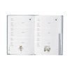 A rustic, navy address and birthday book featuring a large highland cow with 2 small, baby highland cows. Golden text at the top of the card reads "Address and birthday book" by Wrendale Designs.