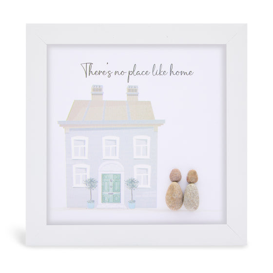 This white shadowbox framed pebble art print features a a beautiful house design as two figures look on. It reads There's no place like home.