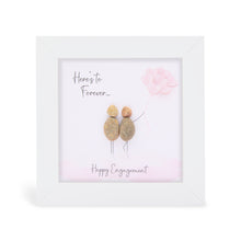  These small white shadow box frame gifts are made with a 4-inch white shadow box frame with a plexiglass insert, helping it be less fragile in the post and around the home. You can also easily take them apart to clean the inside of the glass or frame if you need to. They come individually boxed for added protection during shipping.

This white shadowbox framed pebble art print features 2 people holding a bouque of pink balloons. It reads Here's to Forever! Happy Engagment.