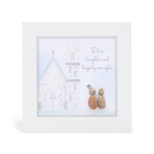  These small white shadow box frame gifts are made with a 4-inch white shadow box frame with a plexiglass insert, helping it be less fragile in the post and around the home. You can also easily take them apart to clean the inside of the glass or frame if you need to. They come individually boxed for added protection during shipping.

This white shadowbox framed pebble art features a beautiful church with a bride and groom outside. It reads To love, laughter, and happily ever after.