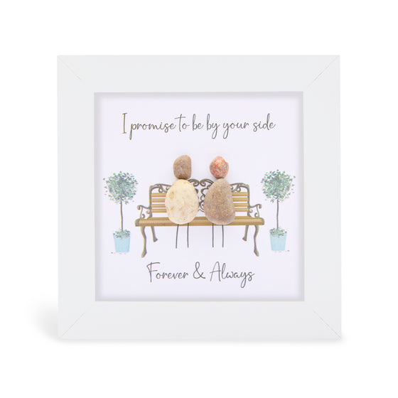 These small white shadow box frame gifts are made with a 4-inch white shadow box frame with a plexiglass insert, helping it be less fragile in the post and around the home. You can also easily take them apart to clean the inside of the glass or frame if you need to.&nbsp; They come individually boxed for added protection during shipping.&nbsp;

This white shadowbox framed pebble art print 2 people sitting on a bench. It reads " Promise to be by your side Forver & Always