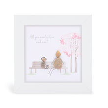  These small white shadow box frame gifts are made with a 4-inch white shadow box frame with a plexiglass insert, helping it be less fragile in the post and around the home. You can also easily take them apart to clean the inside of the glass or frame if you need to. They come individually boxed for added protection during shipping.

This white shadowbox framed pebble art features a person sitting on a bench with a cat. It reads All you need is love and a cat.