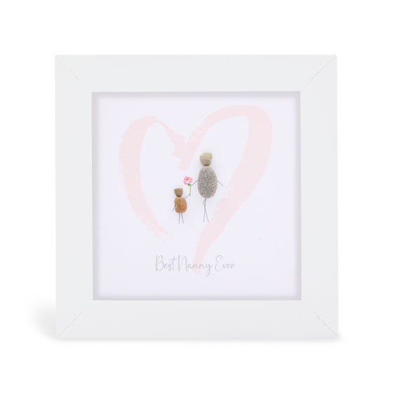 These small white shadow box frame gifts are made with a 4-inch white shadow box frame with a plexiglass insert, helping it be less fragile in the post and around the home. You can also easily take them apart to clean the inside of the glass or frame if you need to. They come individually boxed for added protection during shipping.

This white shadowbox framed pebble art print feature a child and adult walking through a soft pink heart. It reads Best Nanny Ever.
