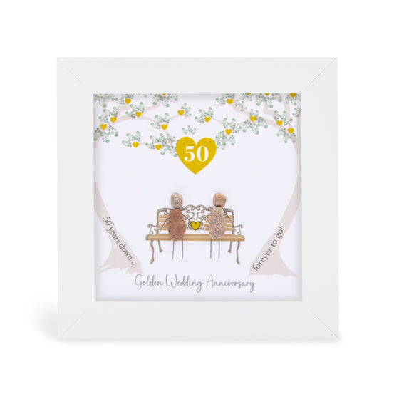 These small white shadow box frame gifts are made with a 4-inch white shadow box frame with a plexiglass insert, helping it be less fragile in the post and around the home. You can also easily take them apart to clean the inside of the glass or frame if you need to.&nbsp; They come individually boxed for added protection during shipping. 
This white shadowbox framed pebble art print features 2 people sitting on a bench Gold Anniversary Gift 50 yrs down Forever to Go