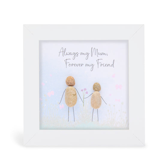 These small white shadow box frame gifts are made with a 4-inch white shadow box frame with a plexiglass insert, helping it be less fragile in the post and around the home. You can also easily take them apart to clean the inside of the glass or frame if you need to. They come individually boxed for added protection during shipping.

This white shadowbox framed pebble art print 2 people holding hands walking in a field. It reads Always my Mum, forever my Friend.