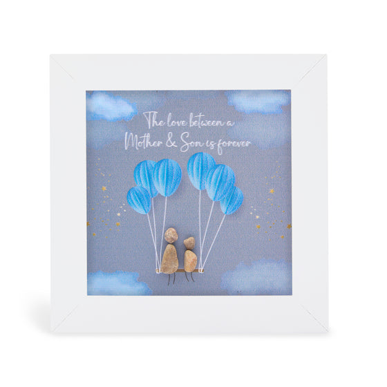 These small white shadow box frame gifts are made with a 4-inch white shadow box frame with a plexiglass insert, helping it be less fragile in the post and around the home. You can also easily take them apart to clean the inside of the glass or frame if you need to. They come individually boxed for added protection during shipping.

This white shadowbox framed pebble art features a beautiful church with a bride and groom outside. It reads The love between a Mother and Son is forever.