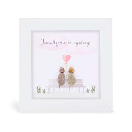 These small white shadow box frame gifts are made with a 4-inch white shadow box frame with a plexiglass insert, helping it be less fragile in the post and around the home. You can also easily take them apart to clean the inside of the glass or frame if you need to.&nbsp; They come individually boxed for added protection during shipping.&nbsp;

This white shadowbox framed pebble art print 2 people sitting on a bench with a pink heart above their heads it reads "you will forever be my always.