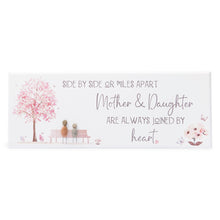  These wood plaques have all been painted white prior to their individual designs being painted on with the pebble art. They measure 32cm (L) x 12cm (W) x 1cm (D) and can be hung on the wall if desired.&nbsp;

This beautiful wood plaque depicts 2 people sitting on a bench under a tree and it reads Side by side or miles apart Mother's &; Daughters are always joined by heart.