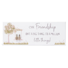  These wood plaques have all been painted white prior to their individual designs being painted on with the pebble art. They measure 32cm (L) x 12cm (W) x 1cm (D) and can be hung on the wall if desired.&nbsp;

This beautiful wood plaque depicts 2 sitting on a swing under a tree and it reads Our friendship isn't a big thing. It's a million little things!