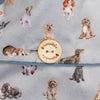 A medium-sized hot water bottle, wrapped in a cozy and incredibly soft light grey cover. Featuring beautiful dog watercolor illustrations by Hannah Dale. A perfect gift for dog lovers, by Wrendale Designs.