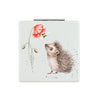 A square compact mirror designed by Hannah Dale, featurig the artwork 'busy as a bee'. The artwork consist of a hedgehog and bee with a red poppy. Wrendale Designs.