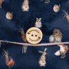 A medium-sized hot water bottle, wrapped in a cozy and super-soft navy fabric, featuring a giant fox and other small woodland creatures, all designed by Hannah Dale for Wrendale Designs; a perfect gift for animal lovers.