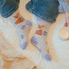 Potting about, high quality bamboo socks, featuring a beautiful illustration by Hannah Dale of a Wren. Baby blue backround, with blue flowers dotted around. A perfect gift for animal lovers. Wrendale Designs.