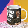Funny men's mug; featuring a well dressed man, in a suit, similing, sitting at a table; big, bold text behind him that reads 'You sir, are a knob'; by Dean Morris.