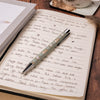 A ballpoint pen featuring gorgeous illustrations by Hannah Dale of watercolour hares. The pen has black ink and silver accents. Good for keeping notes in style. Wrendale Designs.